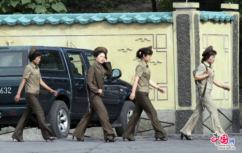 當地時間2014年6月23日，朝鮮新義州，朝鮮女兵身著軍裝從河邊走過。